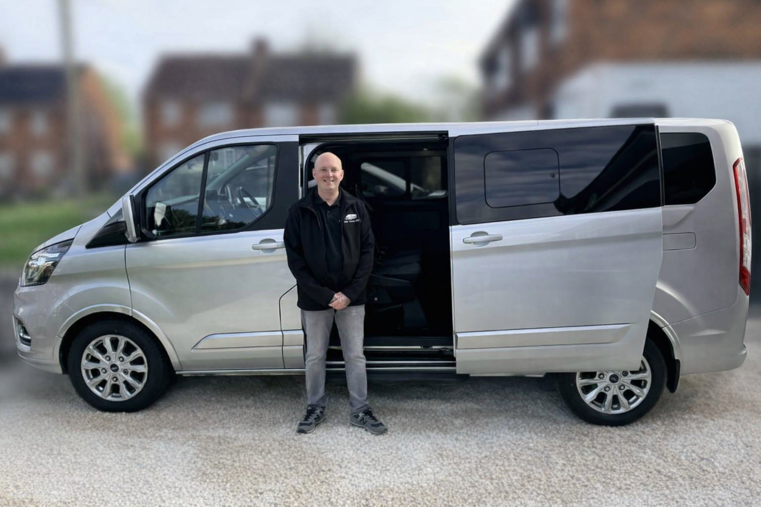 Darren from DHF Travel standing beside the vehicle